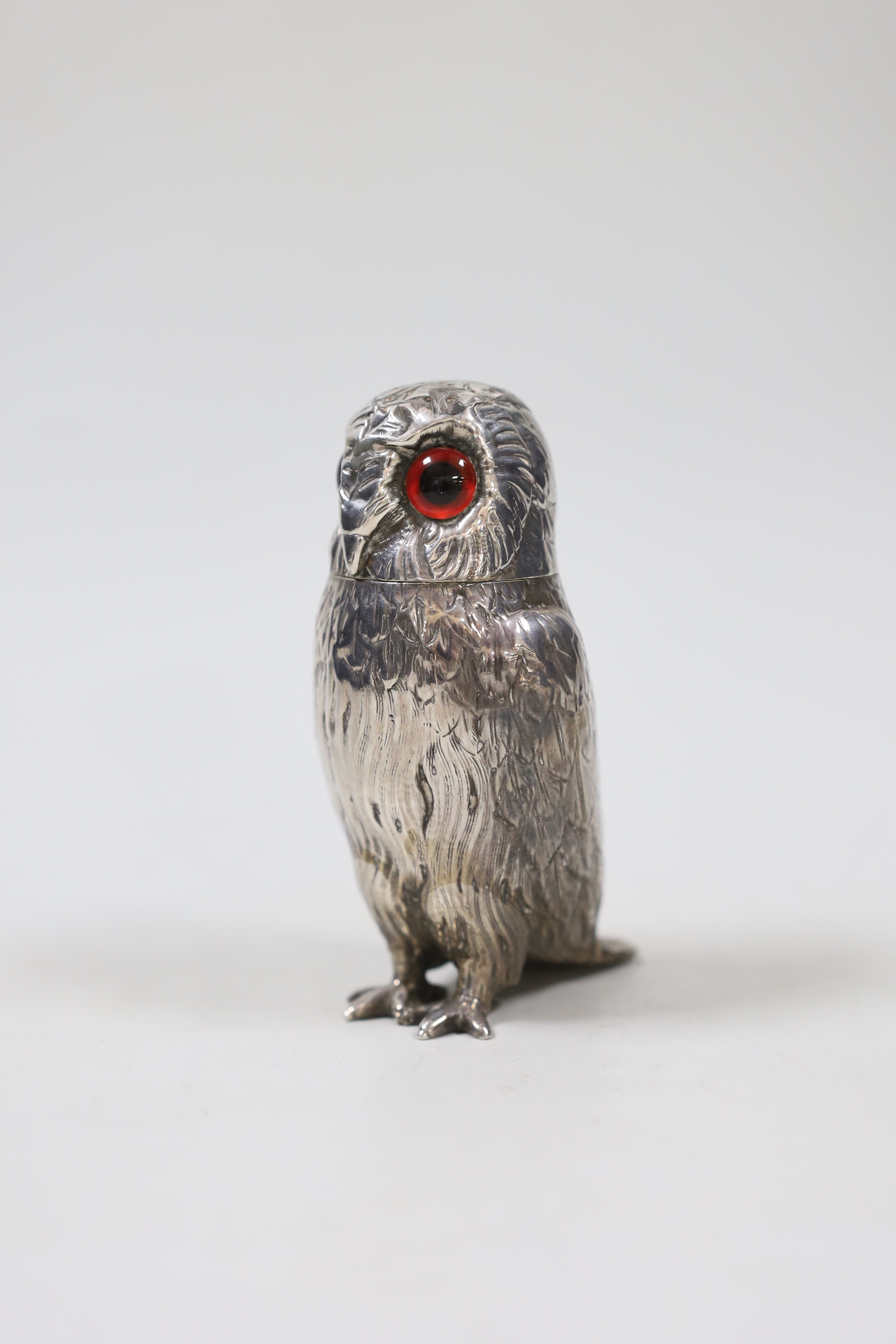 A Victorian novelty silver condiment, modelled as an owl with glass eyes, George John Richards, London, 1853, 9.9cm.